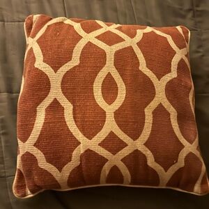 Decorative pillow from Pier One. Rusty red and cream, gently used, zipper open